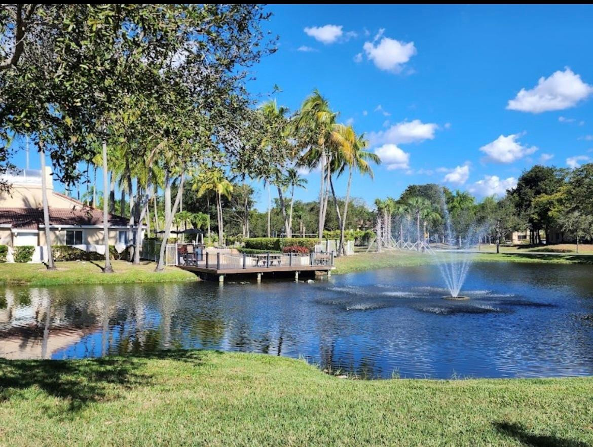 921 Lyons Road, Unit 3105 Coconut Creek, FL 33063 - Photo 2 of 28 a view of yard with tree