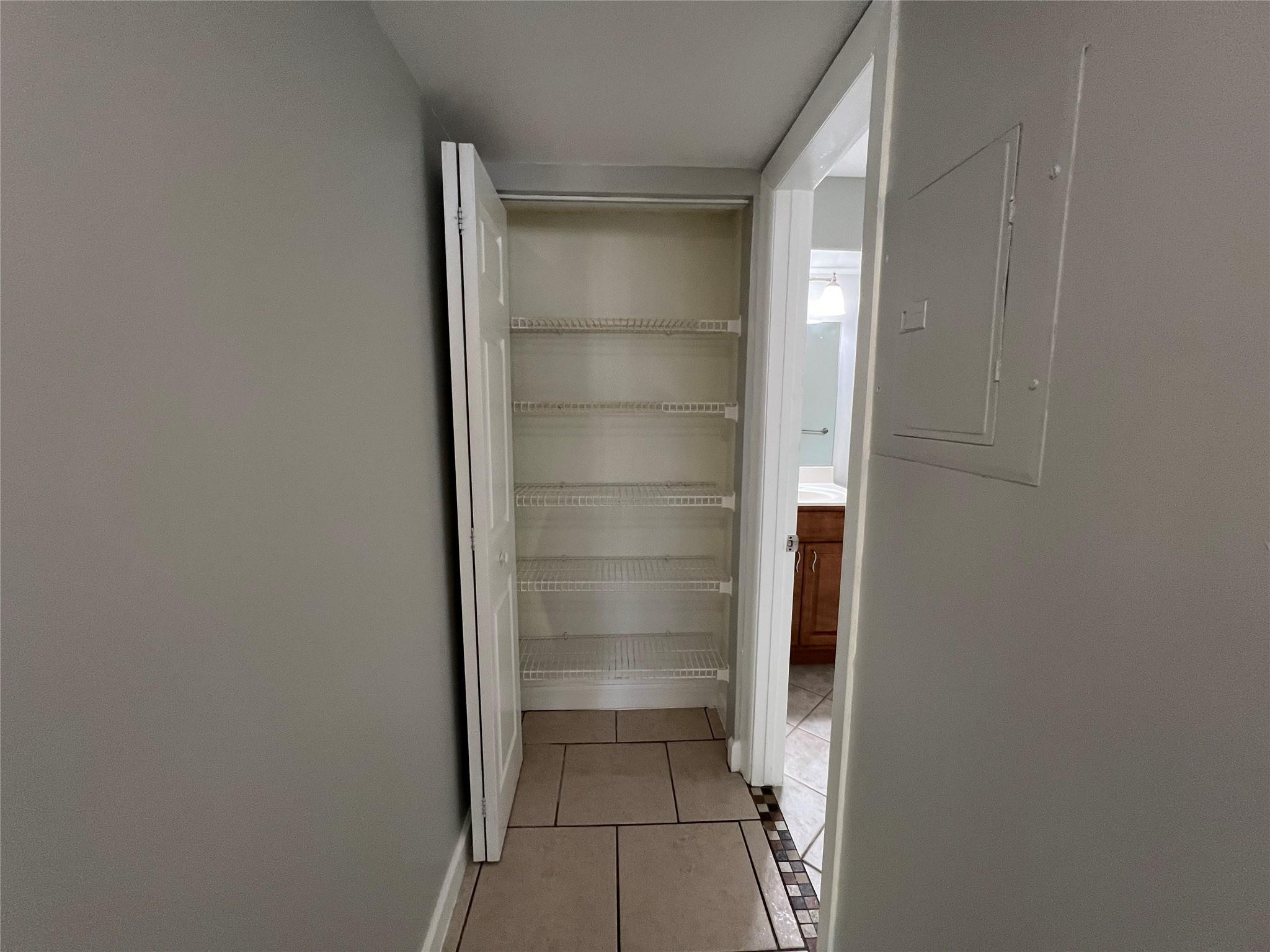 921 Lyons Road, Unit 3105 Coconut Creek, FL 33063 - Photo 23 of 28 a view of walk in closet with empty racks
