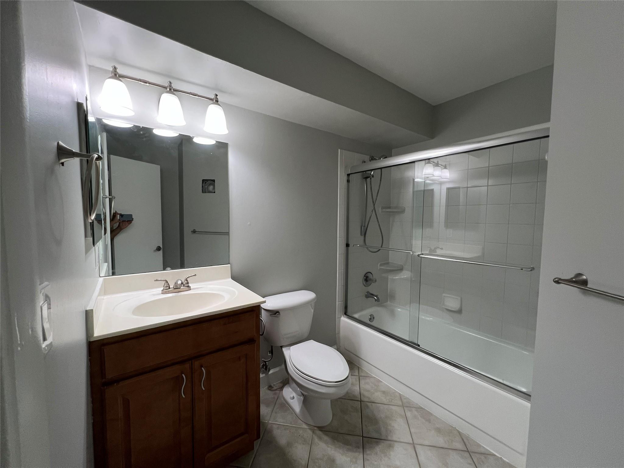 921 Lyons Road, Unit 3105 Coconut Creek, FL 33063 - Photo 24 of 28 a bathroom with a sink a toilet and shower