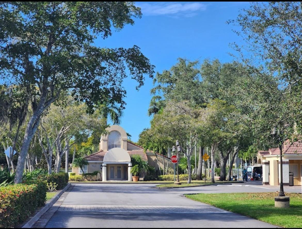 921 Lyons Road, Unit 3105 Coconut Creek, FL 33063 - Photo 26 of 28 a front view of a house with a yard