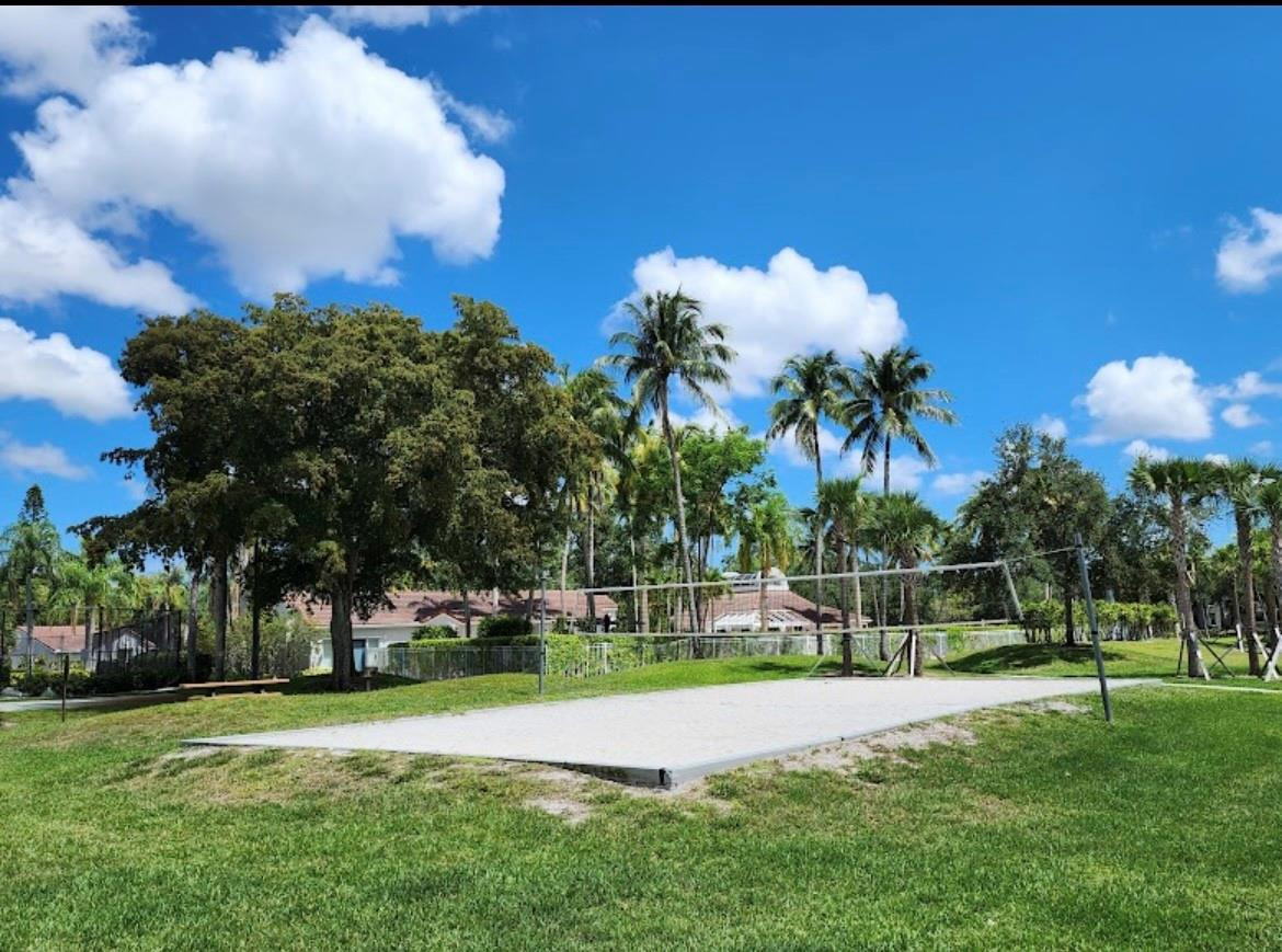 921 Lyons Road, Unit 3105 Coconut Creek, FL 33063 - Photo 27 of 28 a front view of a house with a big yard and a fountain