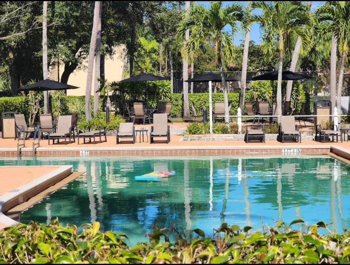 921 Lyons Road, Unit 3105 Coconut Creek, FL 33063 - Photo 3 of 28 a view of a lake with a sitting area