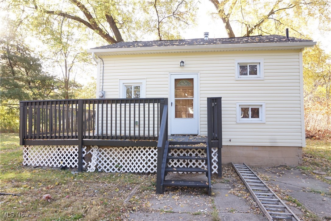 3276 Cottage Grove Road Akron, OH 44319 - Photo 2 of 18 Side view of vinyl sided house with a newly painted deck