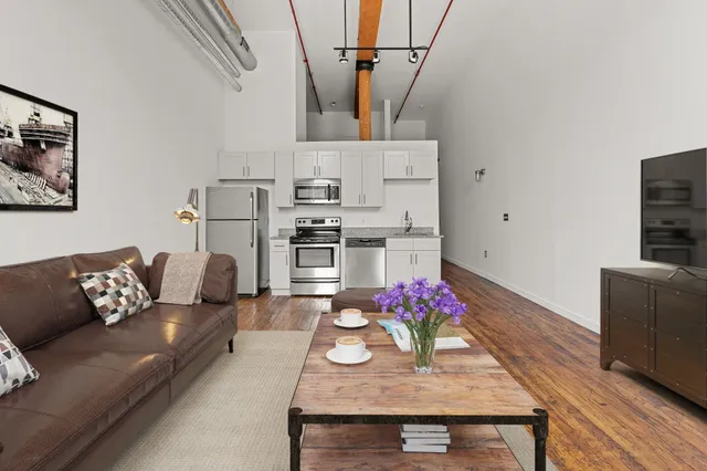 a living room with furniture and kitchen view