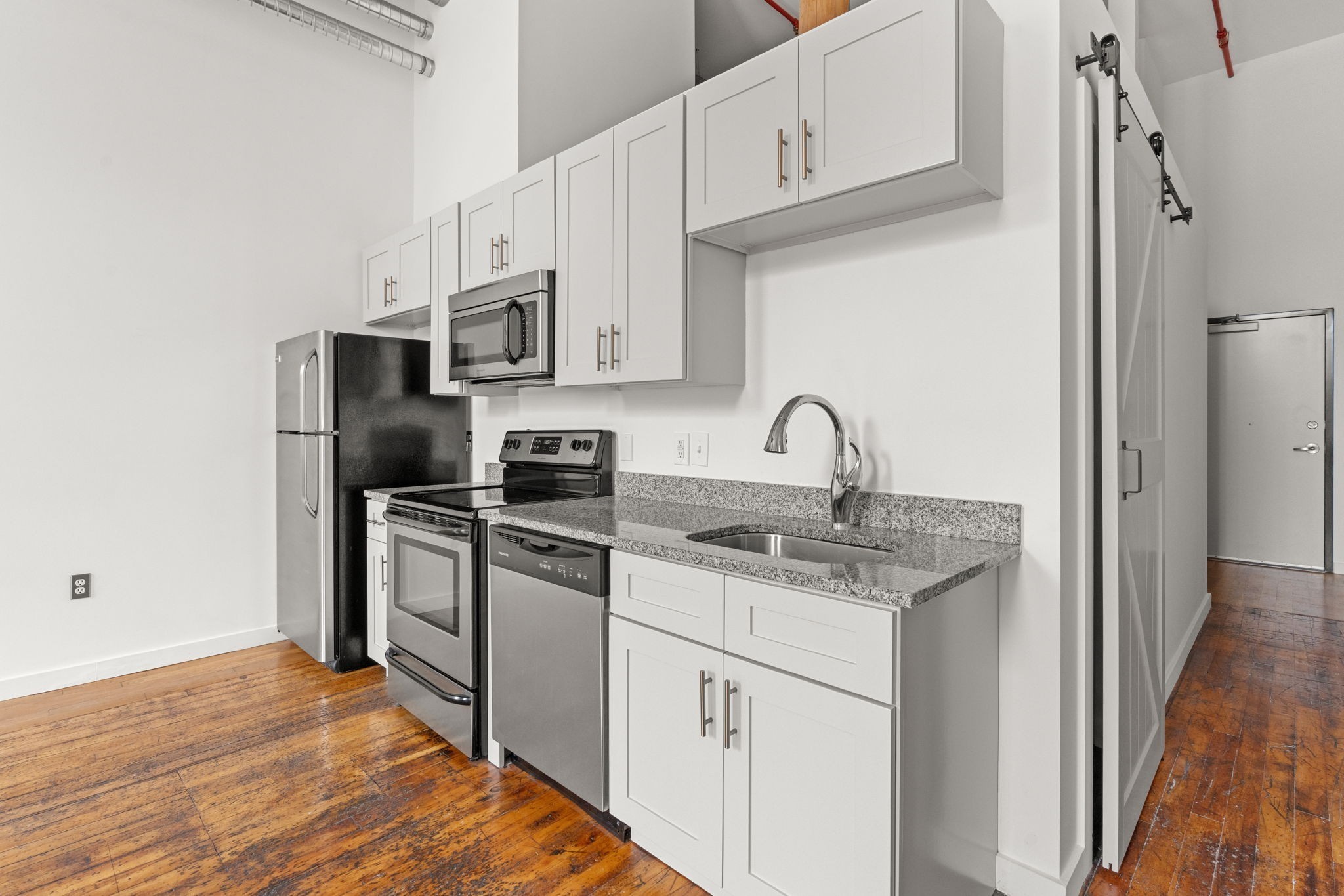 1350 Rosa L Parks Boulevard, Unit 347 Nashville, TN 37208 - Photo 7 of 27 a kitchen with stainless steel appliances granite countertop a sink stove and refrigerator