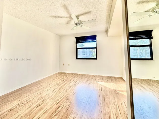 a view of an empty room and wooden floor