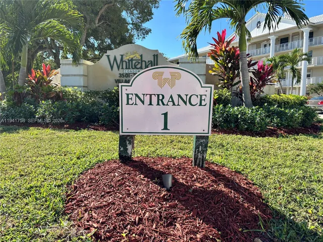 a view of sign board with flower around