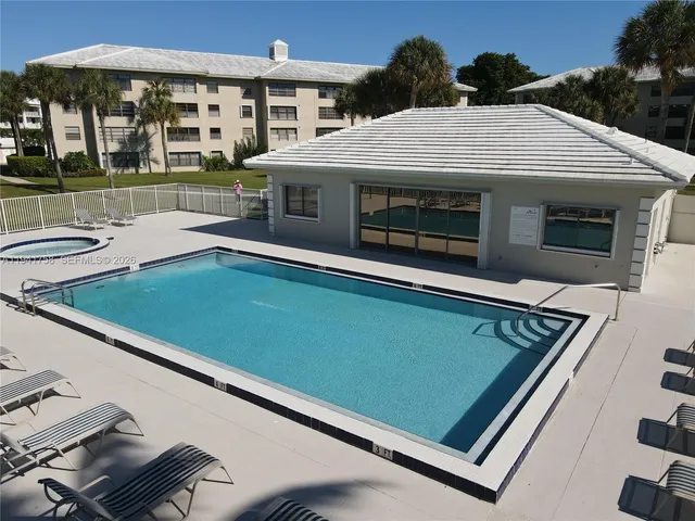 a view of swimming pool with outdoor seating and yard