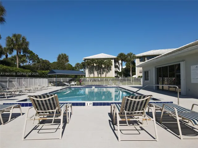 a view of a patio with table and chairs with wooden floor and fence