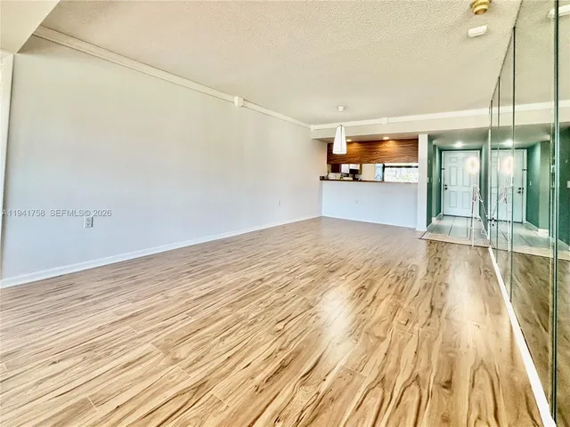 a view of a room with wooden floor