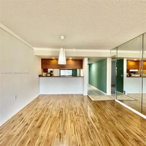 a view of a kitchen with wooden floor