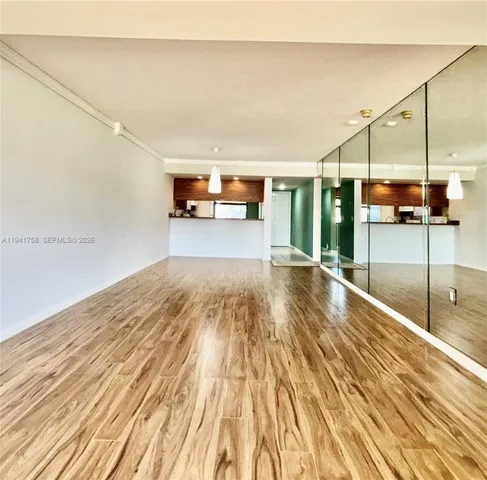 a view of a room with wooden floor