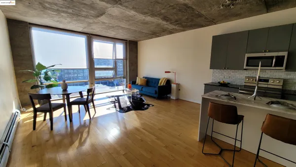 a kitchen with furniture wooden floor and stainless steel appliances