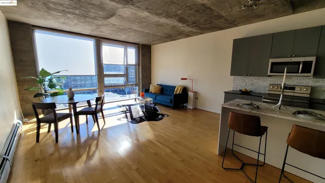 a kitchen with furniture wooden floor and stainless steel appliances