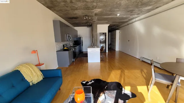 a view of a livingroom with furniture and a kitchen