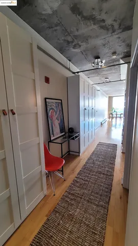 a living room with a bed and a walk in closet