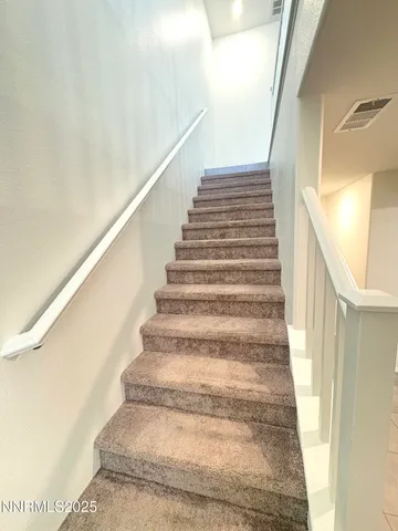 a kitchen with stainless steel appliances kitchen island granite countertop a refrigerator and a stove top oven