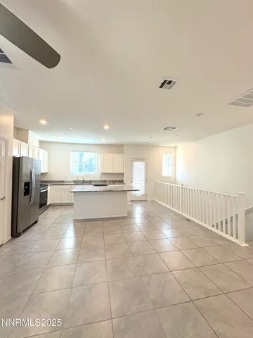a bathroom with a granite countertop toilet a sink and a mirror