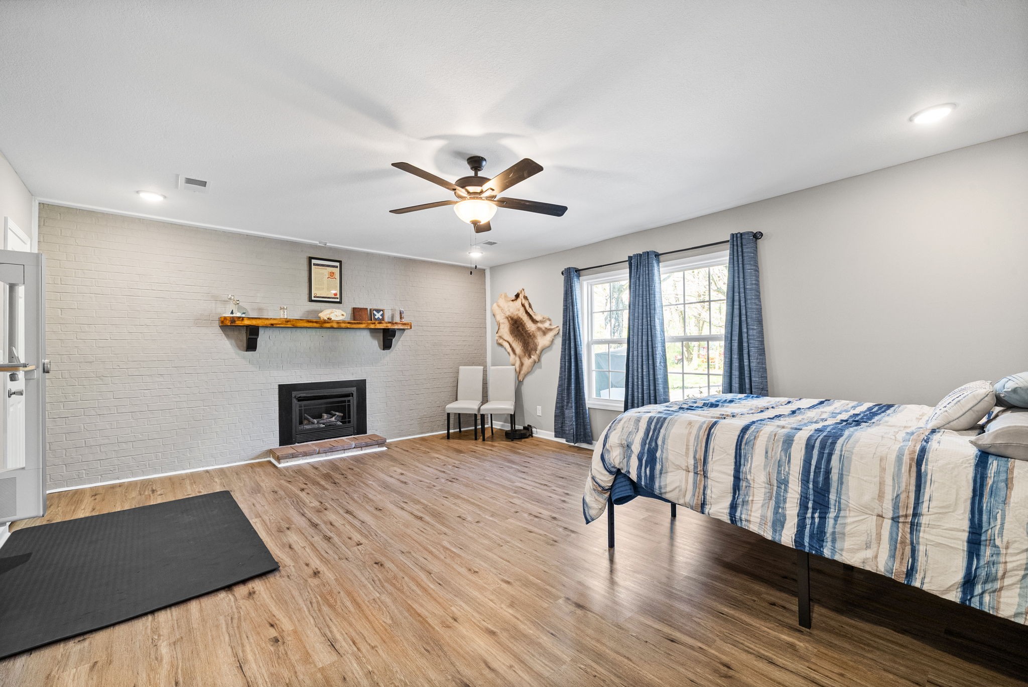 138 Walker Ridge Road Big Rock, TN 37023 - Photo 16 of 37 a spacious bedroom with a bed and a fireplace