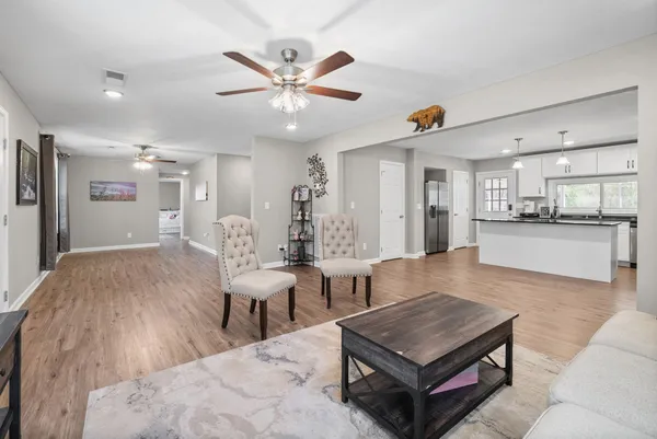a living room with furniture and kitchen view