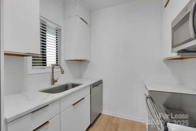 a kitchen with a sink and cabinets