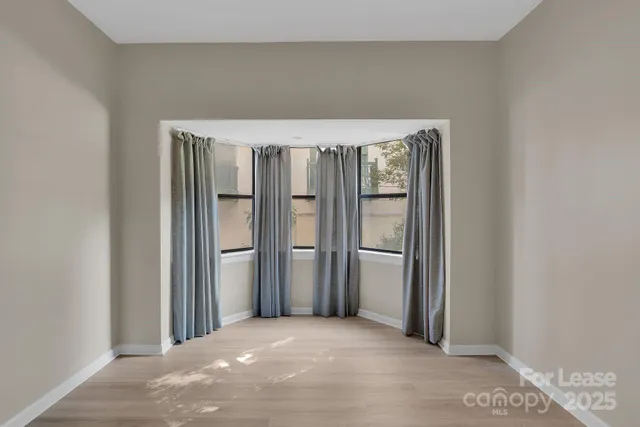 a view of balcony with wooden floor and door