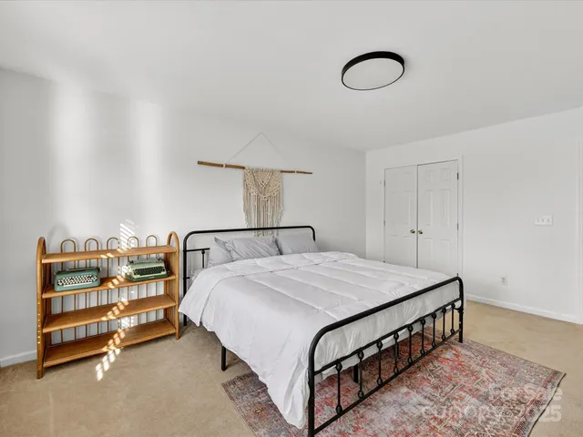 a bedroom with a bed and a night stand