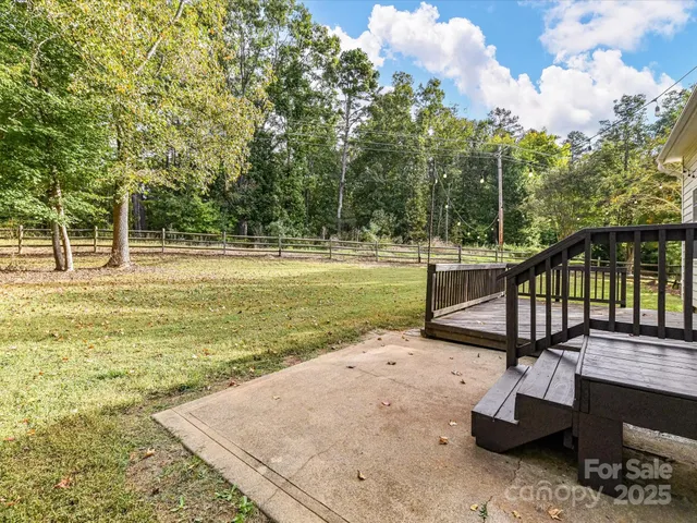 a view of a swimming pool with a yard and sitting area