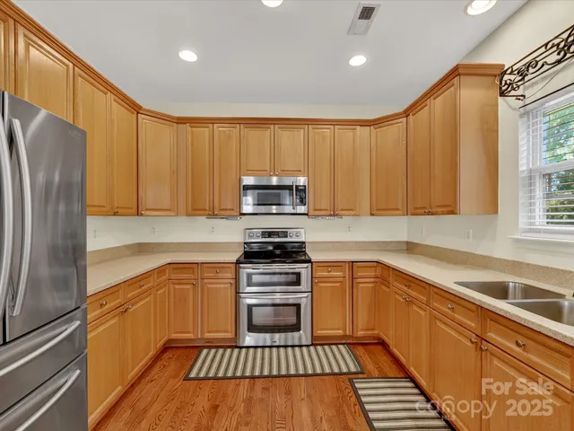 a kitchen with a sink a refrigerator and window