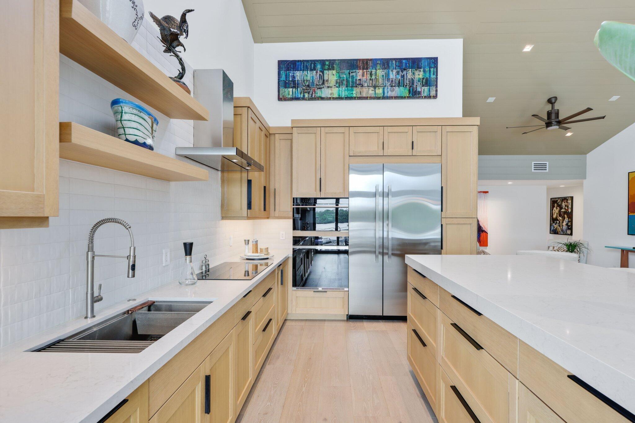 6110 North Ocean Boulevard, Unit 39 Ocean Ridge, FL 33435 - Photo 16 of 59 a large kitchen with stainless steel appliances granite countertop a sink and a stove