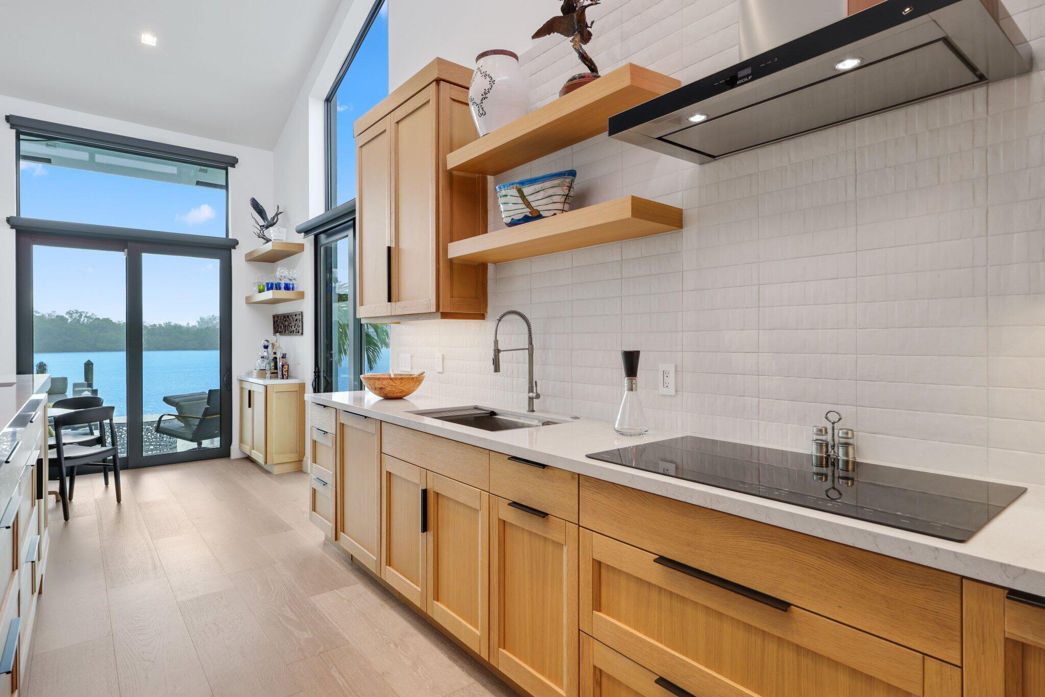 6110 North Ocean Boulevard, Unit 39 Ocean Ridge, FL 33435 - Photo 18 of 59 a kitchen with a sink and a refrigerator