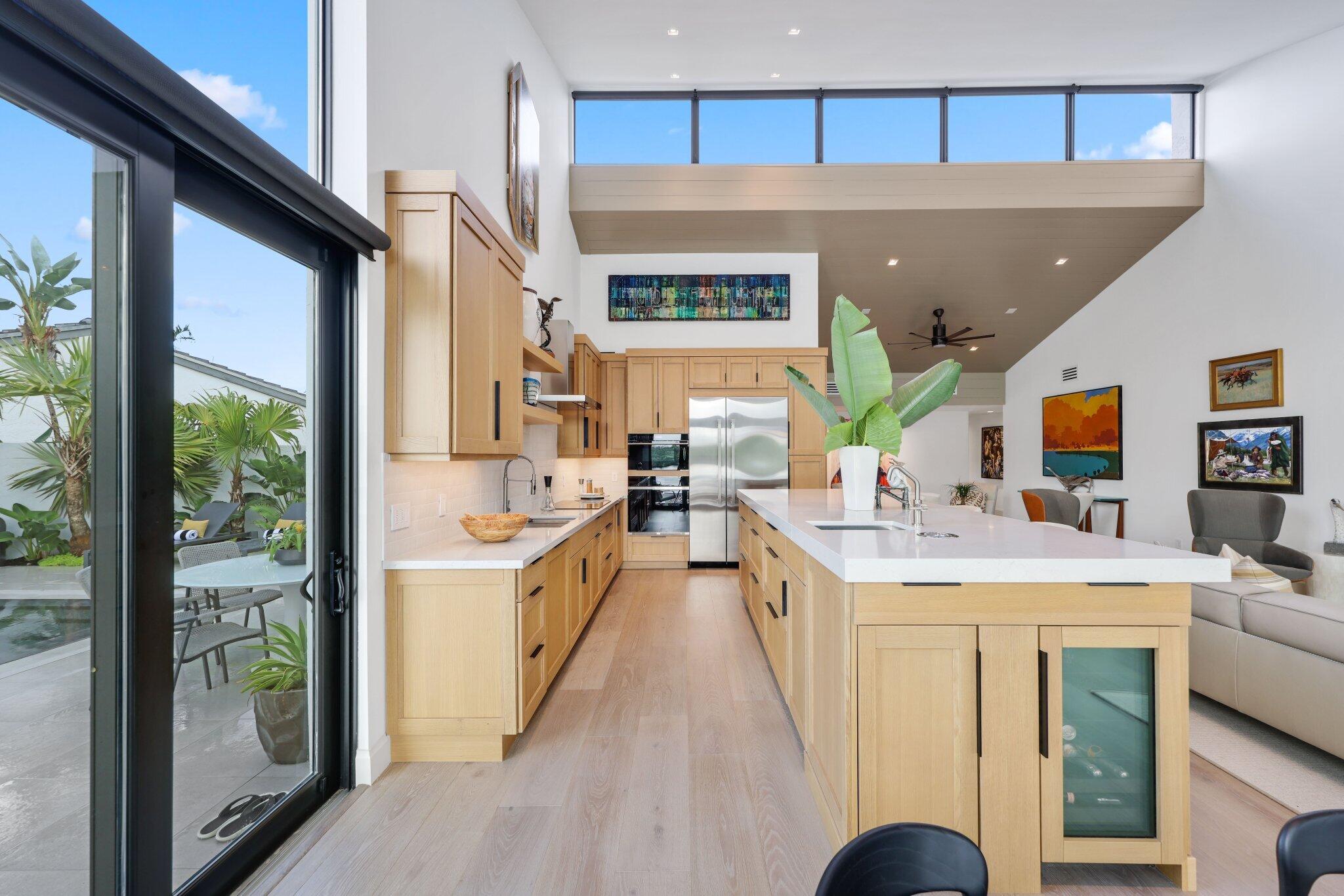 6110 North Ocean Boulevard, Unit 39 Ocean Ridge, FL 33435 - Photo 19 of 59 a large white kitchen with a large window