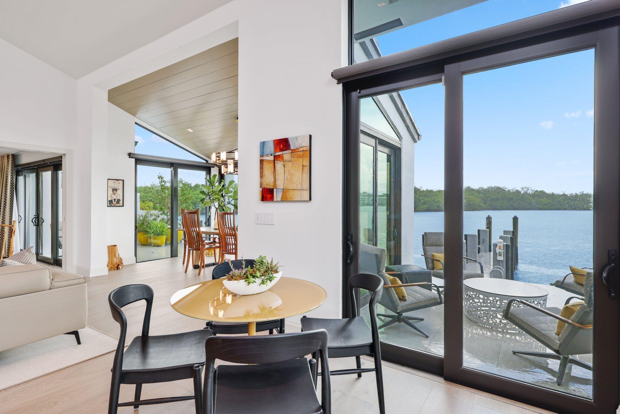 6110 North Ocean Boulevard, Unit 39 Ocean Ridge, FL 33435 - Photo 21 of 59 a view of a dining room with furniture large windows and wooden floor