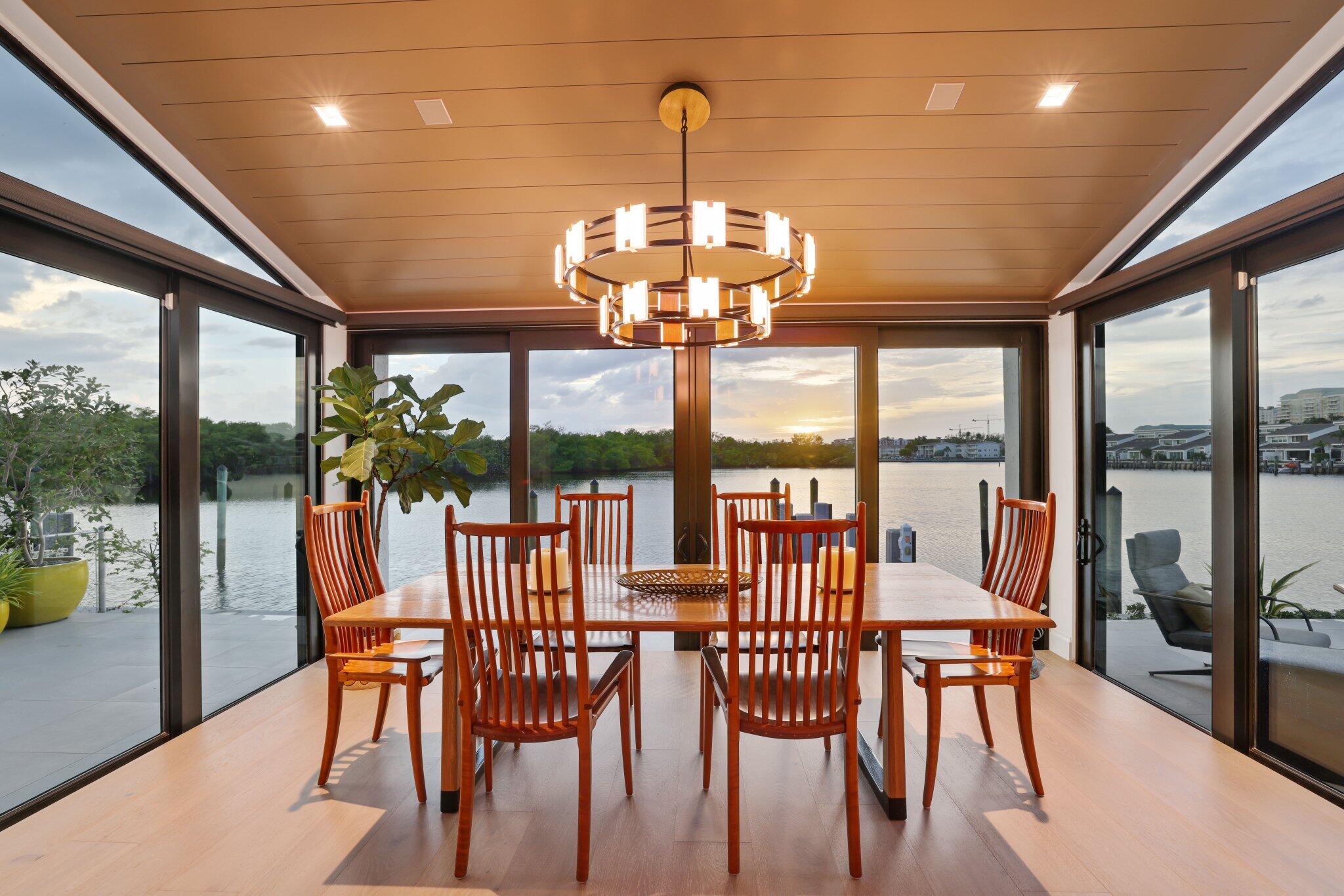 6110 North Ocean Boulevard, Unit 39 Ocean Ridge, FL 33435 - Photo 22 of 59 a view of a dining room with furniture large windows and wooden floor