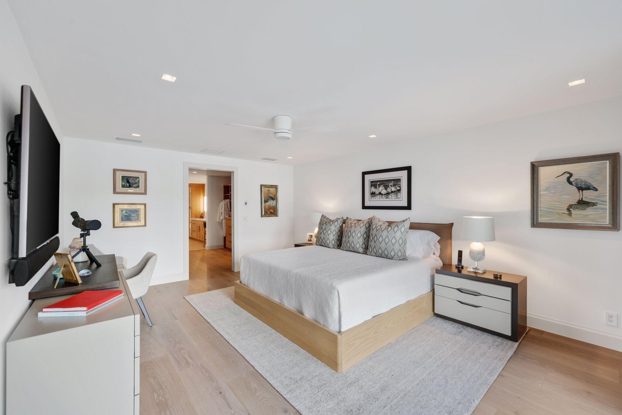 6110 North Ocean Boulevard, Unit 39 Ocean Ridge, FL 33435 - Photo 23 of 59 a bedroom with a large bed and a flat screen tv