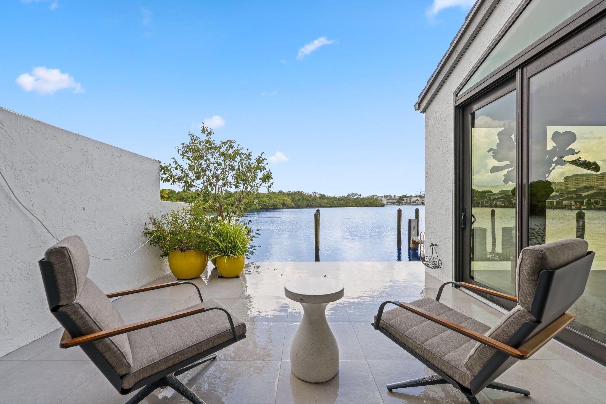 6110 North Ocean Boulevard, Unit 39 Ocean Ridge, FL 33435 - Photo 25 of 59 a outdoor living space with furniture and a potted plant