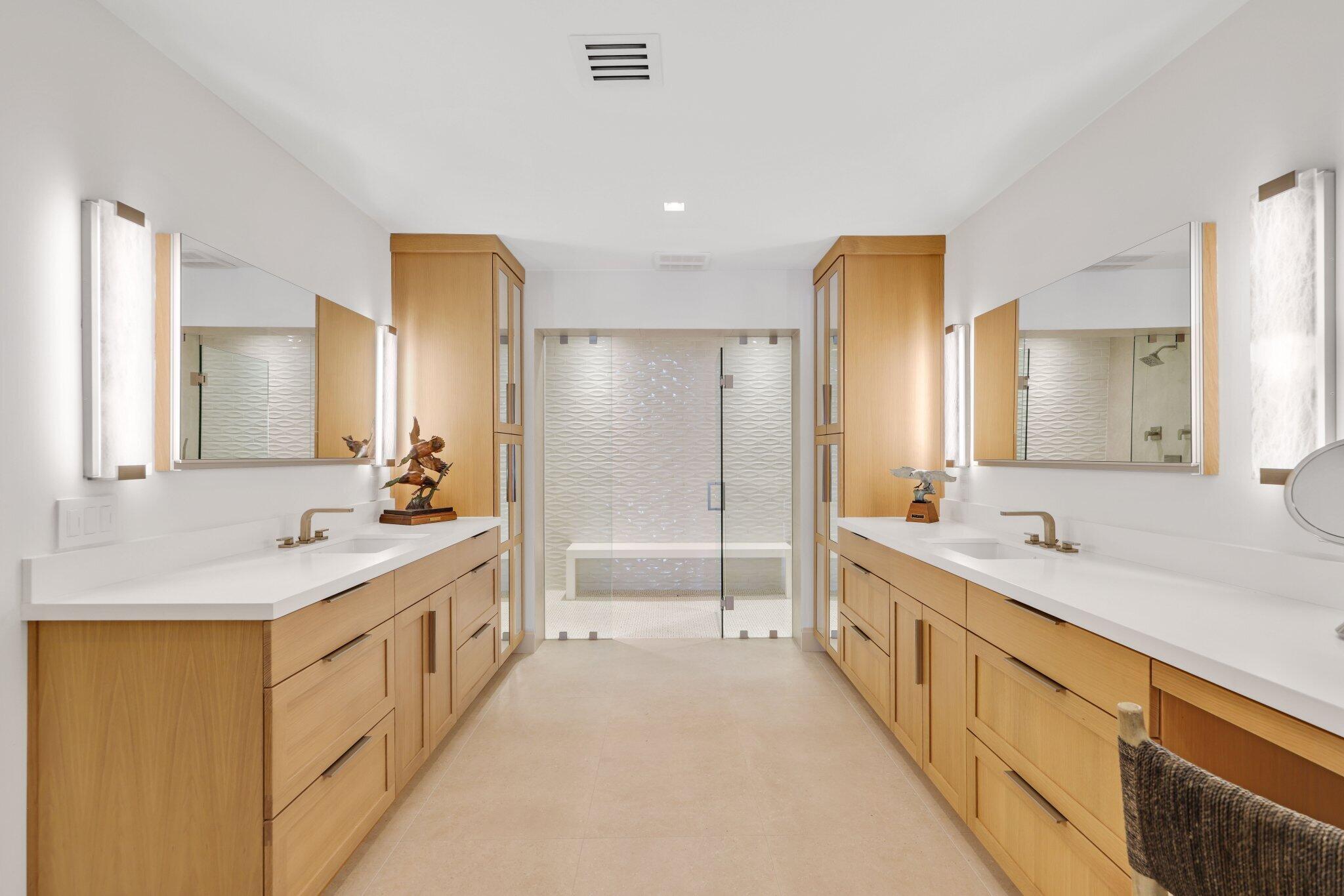 6110 North Ocean Boulevard, Unit 39 Ocean Ridge, FL 33435 - Photo 28 of 59 a large bathroom with a double vanity sink a large mirror and a bathtub