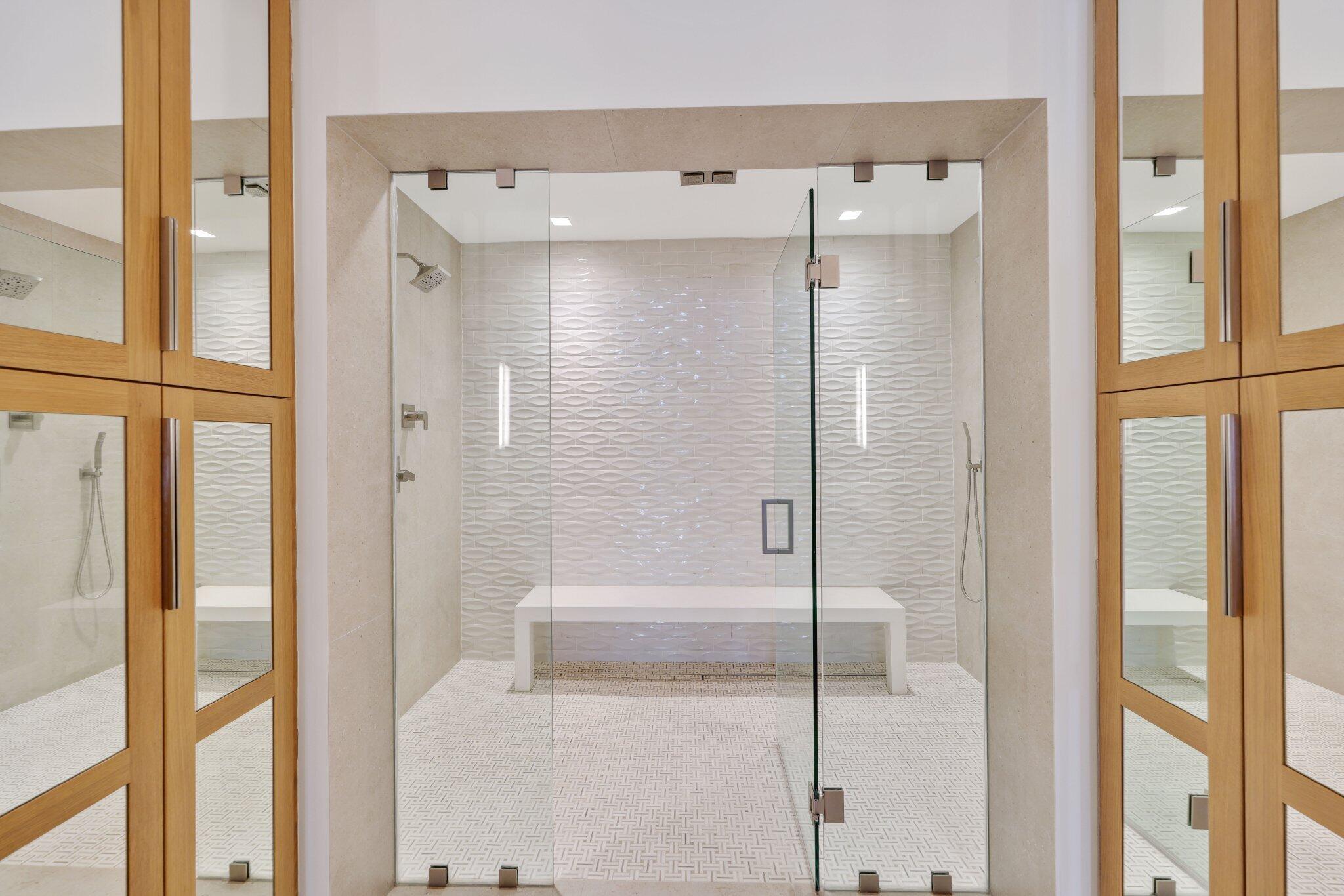 6110 North Ocean Boulevard, Unit 39 Ocean Ridge, FL 33435 - Photo 30 of 59 a bathroom with a glass shower door