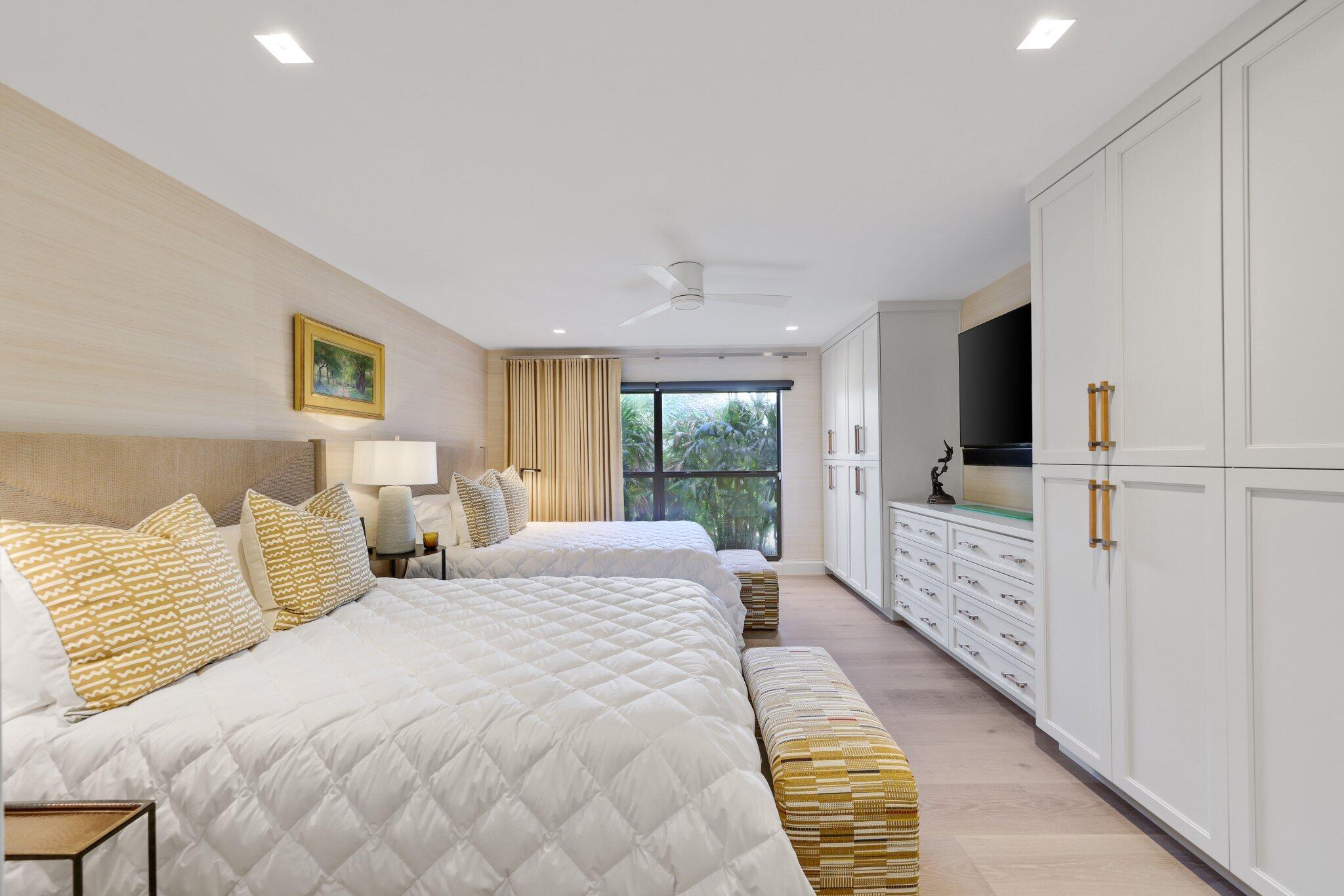 6110 North Ocean Boulevard, Unit 39 Ocean Ridge, FL 33435 - Photo 31 of 59 a bedroom with bed a flat tv screen and a large window