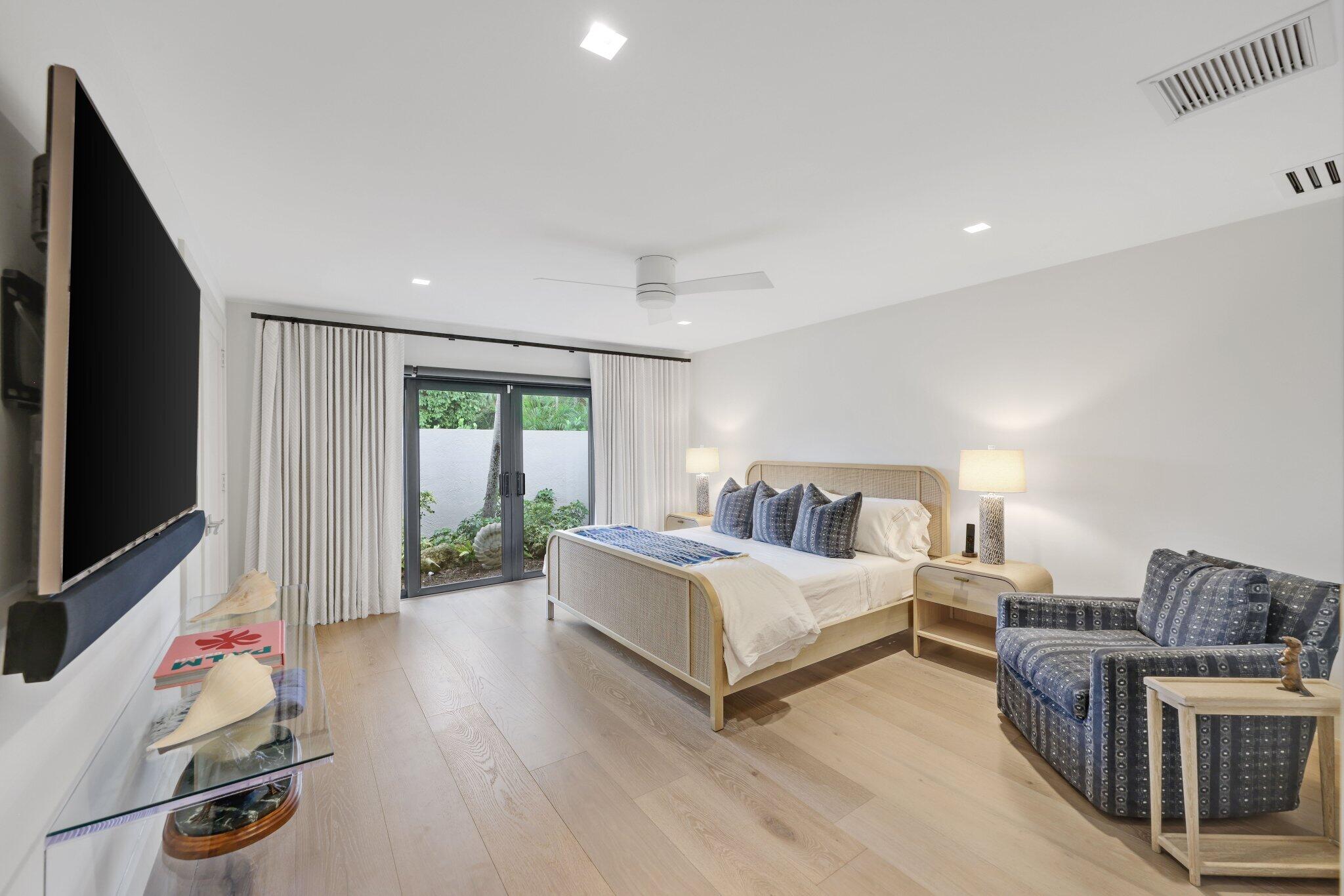 6110 North Ocean Boulevard, Unit 39 Ocean Ridge, FL 33435 - Photo 35 of 59 a bedroom with a bed and a flat screen tv