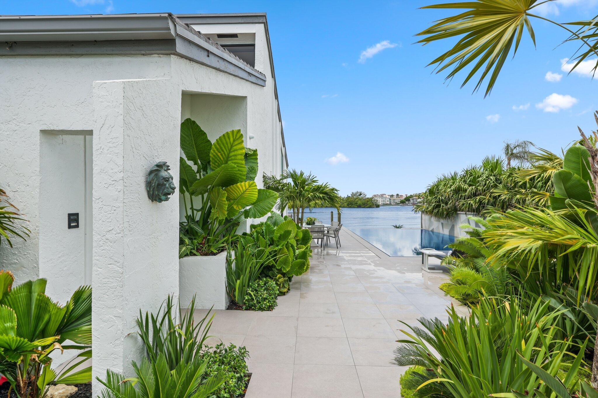 6110 North Ocean Boulevard, Unit 39 Ocean Ridge, FL 33435 - Photo 40 of 59 a plant that is in front of a house