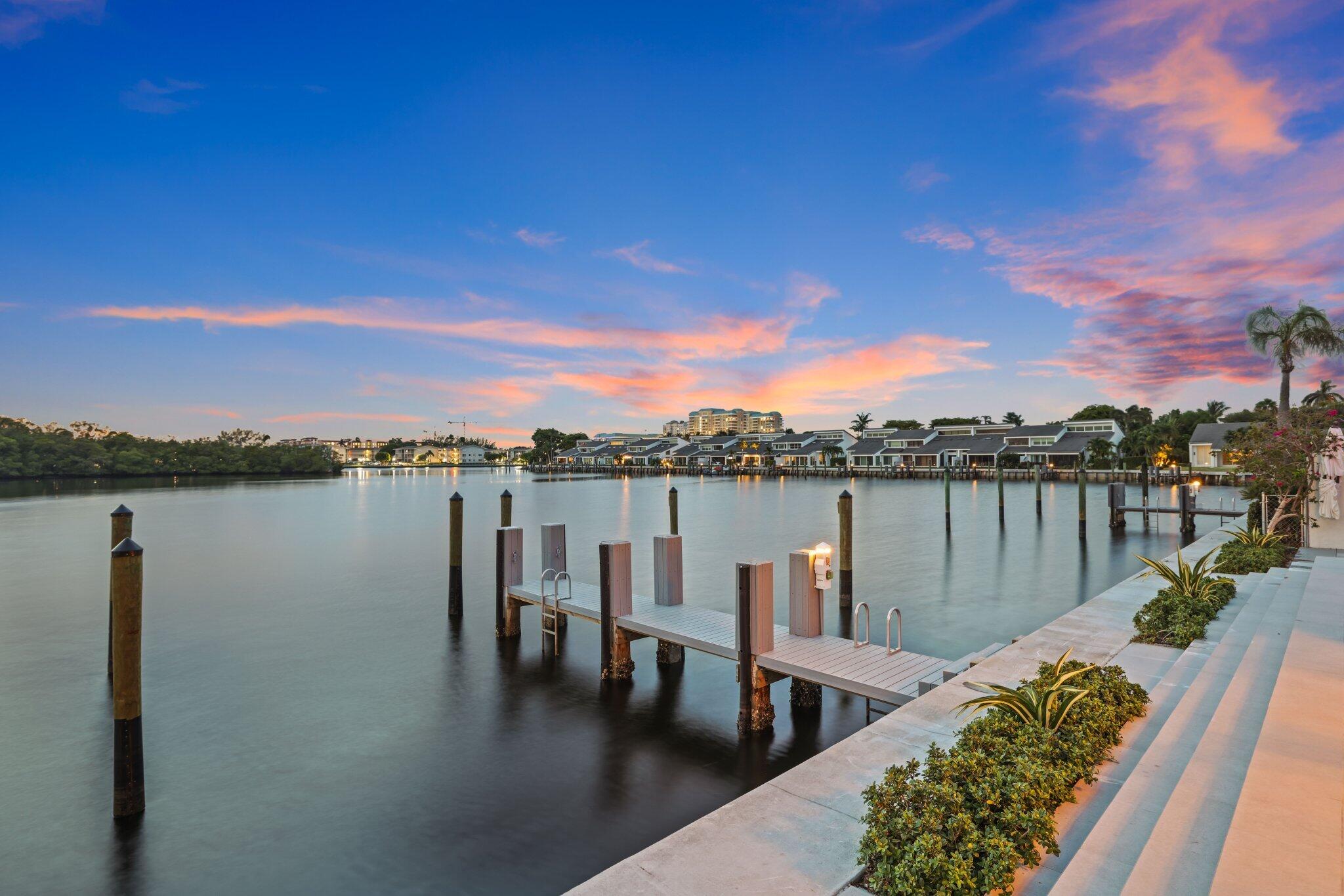 6110 North Ocean Boulevard, Unit 39 Ocean Ridge, FL 33435 - Photo 49 of 59 a view of a lake with a table and chairs