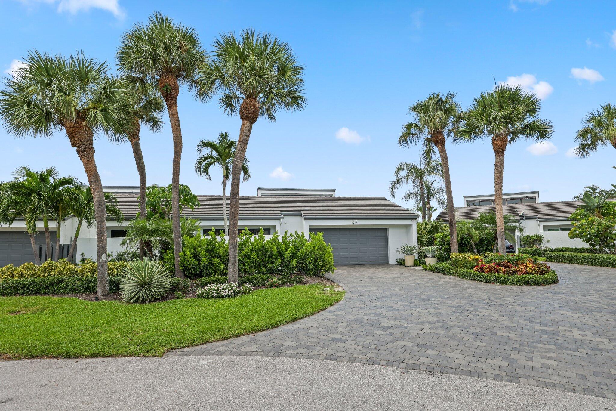 6110 North Ocean Boulevard, Unit 39 Ocean Ridge, FL 33435 - Photo 5 of 59 a front view of a house with garden