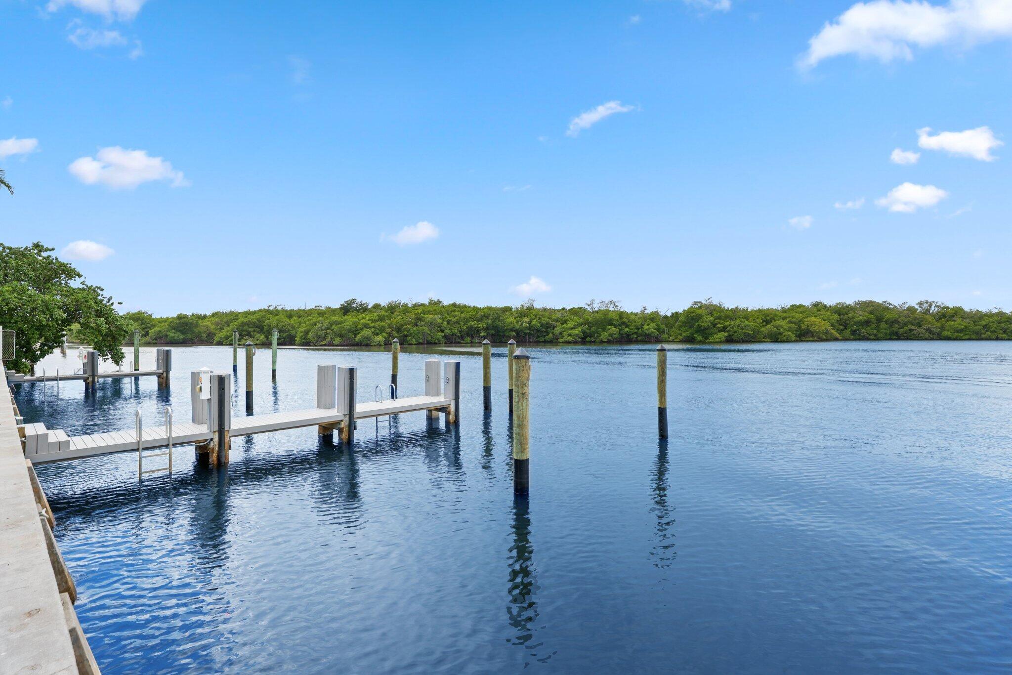6110 North Ocean Boulevard, Unit 39 Ocean Ridge, FL 33435 - Photo 57 of 59 a view of lake with a table and chairs