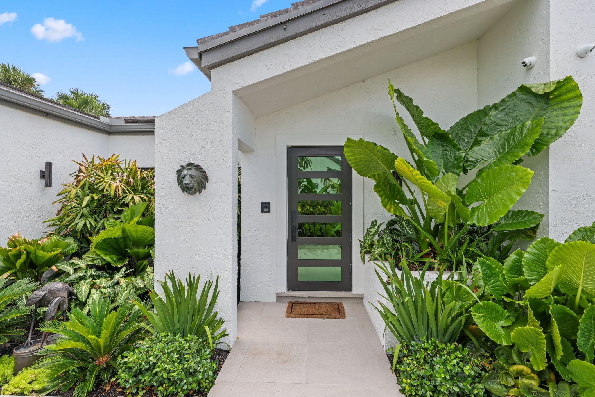6110 North Ocean Boulevard, Unit 39 Ocean Ridge, FL 33435 - Photo 58 of 59 a front view of a house with a plant