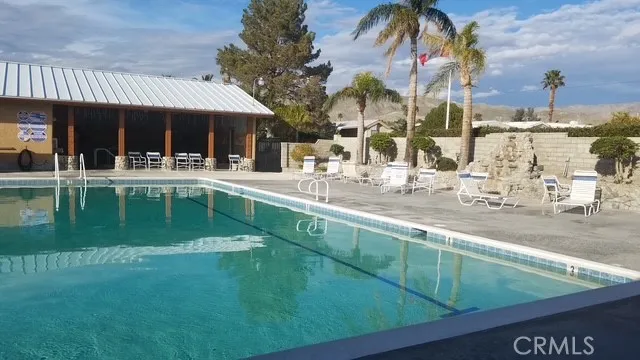 70201 Aurora Road, Unit 176 Desert Hot Springs, CA 92241 - Photo 11 of 17 a view of a house with a swimming pool