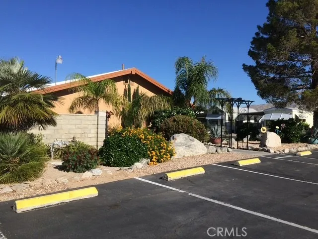 70201 Aurora Road, Unit 176 Desert Hot Springs, CA 92241 - Photo 17 of 17 a view of a house with palm trees