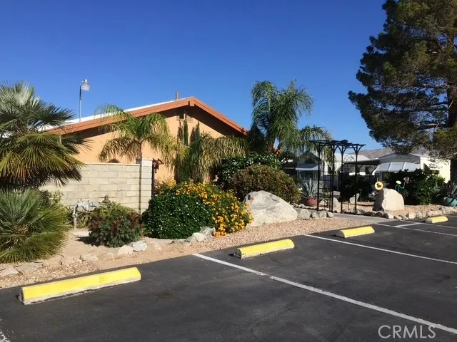 70201 Aurora Road, Unit 176 Desert Hot Springs, CA 92240 - Photo 17 of 17 a view of a house with palm trees