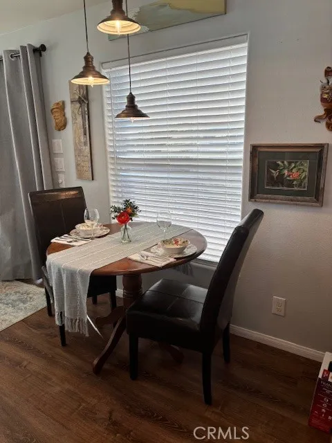 70201 Aurora Road, Unit 176 Desert Hot Springs, CA 92240 - Photo 6 of 17 a dining room with furniture and wooden floor