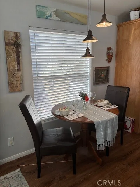 70201 Aurora Road, Unit 176 Desert Hot Springs, CA 92240 - Photo 7 of 17 a dining room with a table chairs and a chandelier